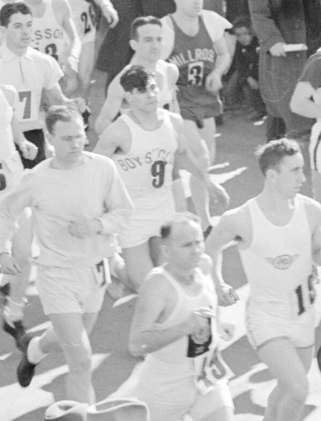 Magnified detail showing a dark haired runner in a singlet lettered BOY'S CLUB above the number 9, with a Millrose runner behind him.